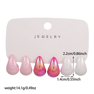 Three pairs of pear-shaped gradient pink acrylic drop earrings shown on jewelry card