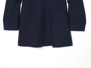 Detailed view of dark blue woven dress hem with side pockets and vertical stitching