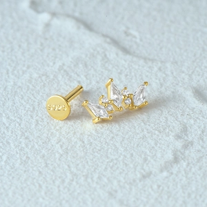 Macro shot of S925 sterling silver gold earring with zircon crown and flat back post