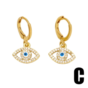 Boucles d'oreilles pendantes œil grec dorées avec pierres bleues et zircons blancs