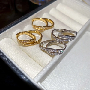Detail of 18k gold and silver U-shaped hoop earrings set with sparkling zircons