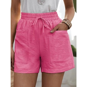 Detail of rose pink linen shorts with elastic drawstring waist and large front pockets
