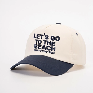 Detail of Let's Go to the Beach embroidery on off-white and navy blue baseball cap