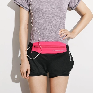 Pink running waist bag detail with earphone jack on model during workout