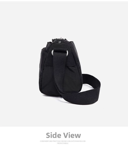 Side view of multi-pocket black nylon crossbody bag with wide strap and zipper