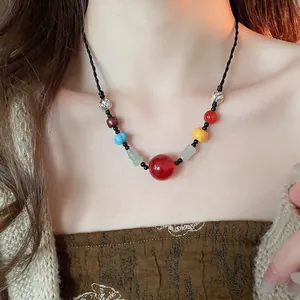 Ethnic beaded necklace with round stone pendants and resin wood beads on a model