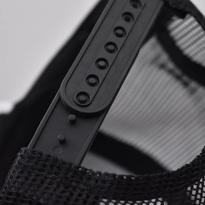 Detail of adjustable snapback closure on a black breathable mesh trucker baseball hat