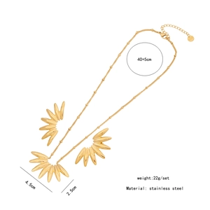 Macro view of gold stainless steel necklace and earring set with product dimensions
