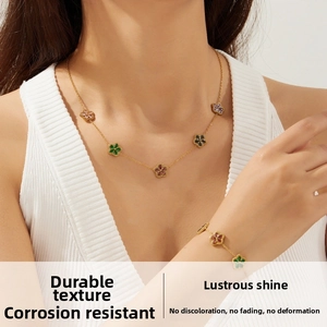 Detail of colorful five-petal flower necklace and bracelet set on model's neck and wrist