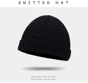 Detailed texture of black knitted beanie hat with comfortable soft skin-friendly fabric