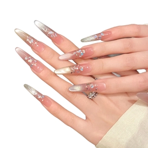 Extra long stiletto press-on nails with nude pink gradient and champagne silver glitter