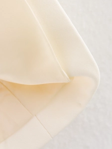 Detailed macro shot of premium cream-colored textile fabric texture with fine weaving