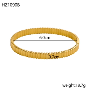 Macro view of gold stainless steel bangle showing vertical pleat texture and 0.7cm width