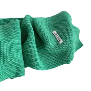 Thick emerald green wool knit scarf with premium handmade woven label detail