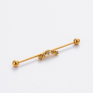 Detailed view of a gold industrial barbell with five sparkling white zircon gemstones