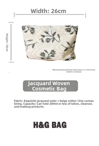 Detail view of cotton linen cosmetic bag with green floral embroidery and dimensions