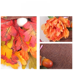 Detailed view of autumn wreath featuring maple leaves, silk flowers, and burlap elements
