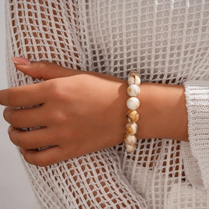 Close-up of bohemian style beaded bracelet with marble texture beads on wrist