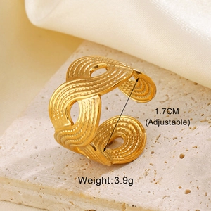 Close-up of golden irregular geometric wavy ring on beige stone with 1.7cm size tag