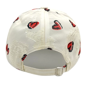 Detail of white baseball cap back showing textured fabric and silver metal buckle