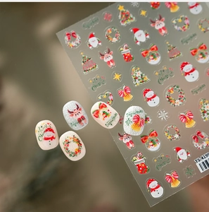 Macro view of 3D embossed Christmas nail stickers featuring snowman and reindeer designs
