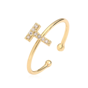 Detailed view of a gold-plated T-shape open ring with clear cubic zirconia crystal accents