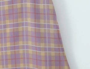 Detailed close-up of the vintage colorful plaid fabric with textured grain for the skirt set