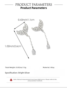 Detail of mermaid tail earrings with sparkling zircon and teardrop crystal pendants
