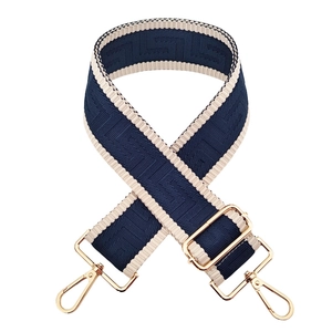 Navy and beige woven 5cm wide bag strap with golden metal hooks on white background