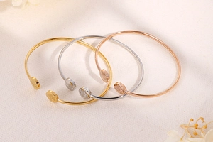 Detailed engraving of Hope and Tree of Life on gold, silver, and rose gold open bangles