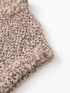 Macro view of beige and dark brown chunky knit wool blend vest fabric texture