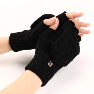 Close-up of black knitted convertible gloves with wood button and thick wool texture