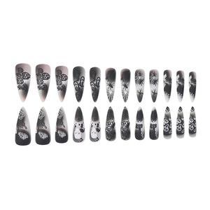 Matte Halloween press-on nails set with skull and spider web designs on long stiletto tips