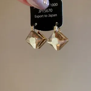 Elegant champagne diamond rhombus ear clips in gold finish for women without piercings