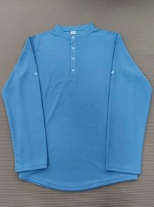 Close-up of sky blue waffle knit polo shirt showing fabric texture and size L neck label