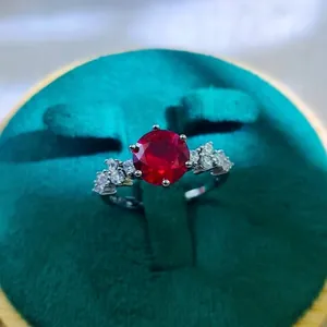 Macro shot of 2 carat red ruby style ring in a green velvet jewelry box