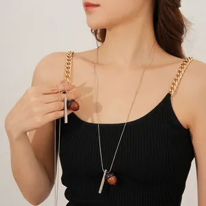 Minimalist wooden acorn pendant necklace with thin silver chain on model, luxury fashion style