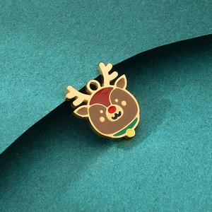 Detailed macro shot of a Christmas reindeer charm with brown enamel and gold plating