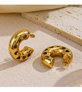Detailed view of 18K gold plated stainless steel C-shaped earrings with hollow heart pattern