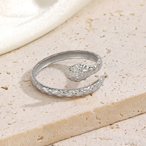 Minimalist silver snake-shaped stainless steel open ring with scale texture on stone