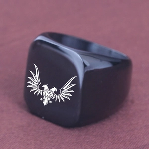 Macro shot of the black stainless steel square ring featuring a white double-headed eagle engraving