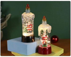 Detail of Christmas LED candle lights featuring Santa Claus figurines and swirling glitter