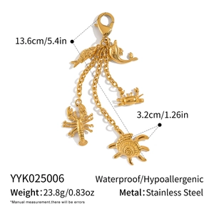 Detail of gold stainless steel ocean charms including lobster, crab and turtle elements