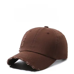 Detailed macro view of brown vintage washed cotton baseball cap with distressed torn holes