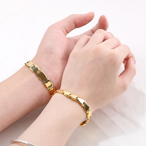 Close-up of golden puzzle interlocking link bracelets with magnets for couples