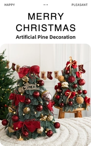 Macro detail of artificial pine Christmas tree with red bows, gold shells and warm LED lights