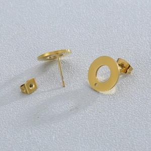 Macro detail of gold stainless steel round stud earring components with secure backings