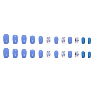 Flat lay of 24pcs deep ocean blue glitter and butterfly nail set in medium square shape