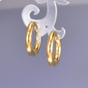 Close-up of thick gold-plated stainless steel hoop earrings with a high-polished finish