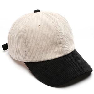 Corduroy baseball cap in contrast beige and black colors with a classic adjustable strap